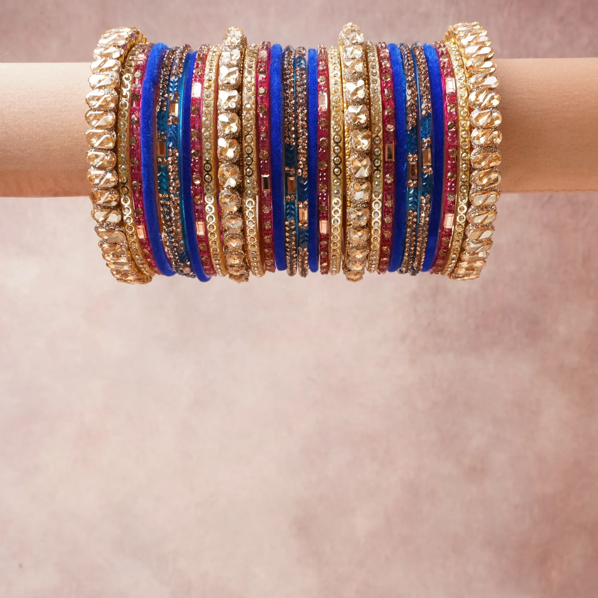 A commanding Deep Royal Blue anchors this beautiful set, enriched with accents of Champagne that add depth and dimension.

Featuring a striking composition of Velvet Fabric, Gold-toned Base Metal, Kundan Cut Glass, Rhinestones, this set carries intricate craftsmanship and strong presence. Grand in form, it is created for moments that deserve to be marked.